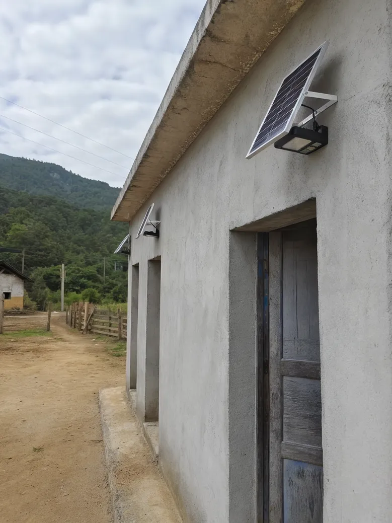 Solar wall lights installed on a rural off-grid building in a remote location