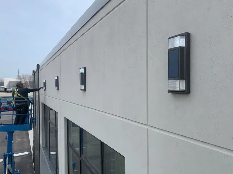 Up down solar wall lights installed on a commercial building facade during a retrofit upgrade project