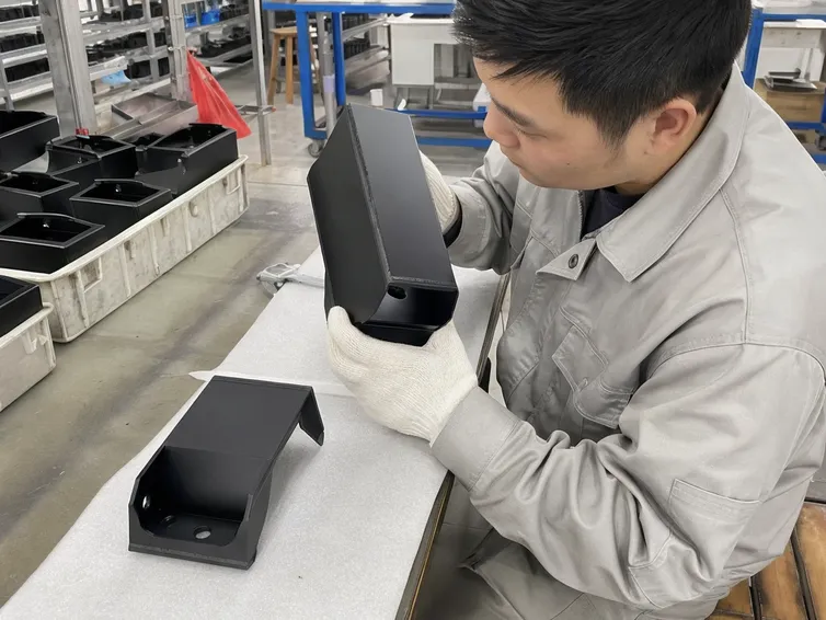 Powder coat finish inspection on solar wall light housing at weld seams