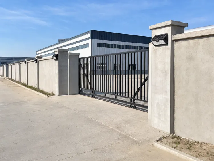 Wireless solar wall lights along a logistics park perimeter wall and gate area