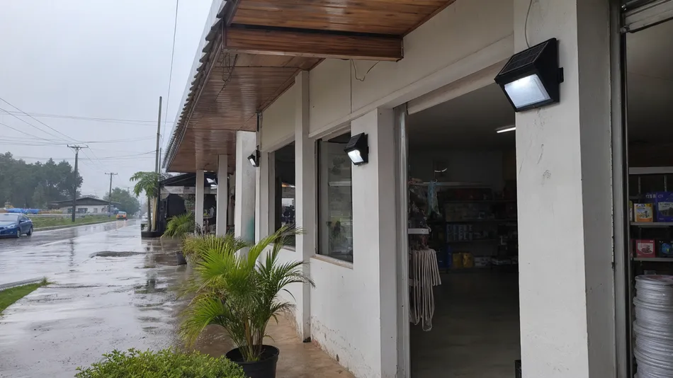 Solar wall lights installed in a tropical retail environment during monsoon season