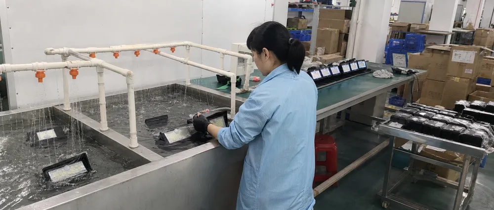 JXSOL IP test station performing unit-level waterproof inspection on solar wall lights before final packing